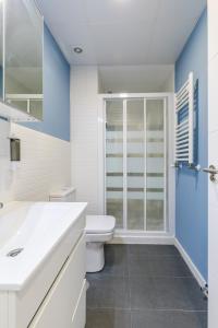a white bathroom with a toilet and a shower at AYZ Villegas - Auto check-in property in Madrid