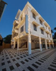 a building covered in christmas lights at Enpathil Residency in Kollam
