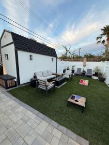 a backyard with a couch and chairs and a table at Private 3BR Home - Hot Tub, Yard, Arcade & Parking in Simi Valley