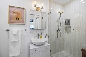 a white bathroom with a sink and a shower at Private 3BR Home - Hot Tub, Yard, Arcade & Parking in Simi Valley +86 photos