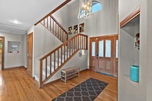 a living room with a staircase with a rug at Three Lakes Haven - Pacific Retreats in Manson