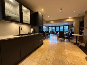 a kitchen with a counter and a dining room at Number One Hundred Bed And Breakfast in Cardiff