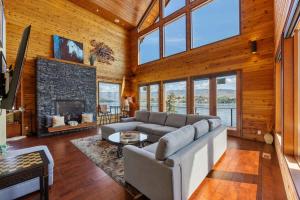 a living room with a couch and a fireplace at Constellations Lake House at Chelan - Pacific Retreats in Chelan