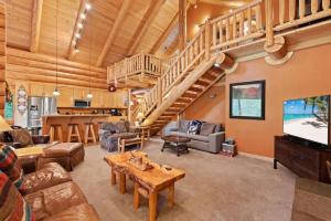 a living room filled with furniture and a staircase at Big Jim Mountain Lodge - Pacific Retreats in Leavenworth