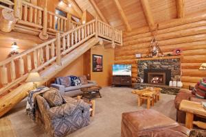 a living room with a staircase and a fireplace at Big Jim Mountain Lodge - Pacific Retreats in Leavenworth