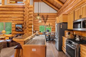 a kitchen with wooden walls and a dining room at Big Jim Mountain Lodge - Pacific Retreats in Leavenworth +37 photos