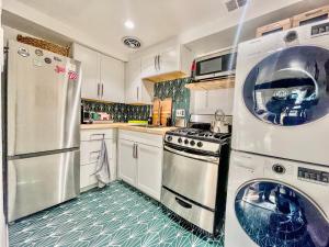 a kitchen with a stove and a washer and dryer at Capitol Hill Carriage House in Washington, D.C. +13 photos