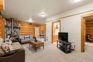 a living room with a couch and a piano at Bear Ridge Cabin - Pacific Retreats in Leavenworth