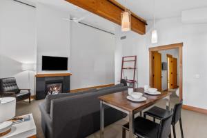 a living room with a couch and a table and a fireplace at Valhalla - Pacific Retreats in Leavenworth