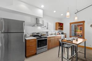 a kitchen with a stainless steel refrigerator and a wooden table at Valhalla - Pacific Retreats in Leavenworth +16 photos