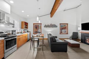 a kitchen and living room with a couch and a table at Valhalla - Pacific Retreats in Leavenworth