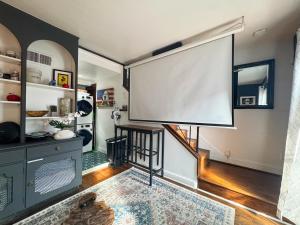 a room with a large screen on the wall at Capitol Hill Carriage House in Washington, D.C.