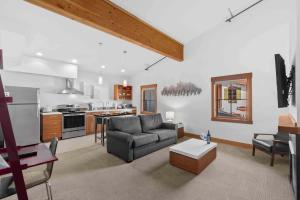 a living room with a couch and a kitchen at Front Street Suites - Pacific Retreats in Leavenworth