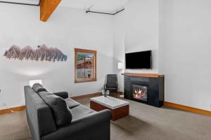 a living room with a couch and a fireplace at Front Street Suites - Pacific Retreats in Leavenworth