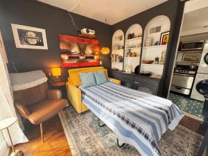 a bedroom with a bed and a chair in it at Capitol Hill Carriage House in Washington, D.C.