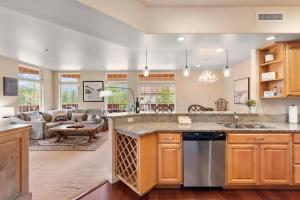 a kitchen with a large counter top and a living room at Apres Ski Chalet - Pacific Retreats in Leavenworth