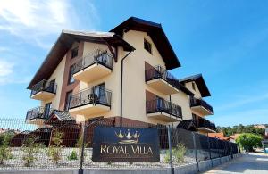 a building with a sign in front of it at ROYAL Villa RESORT & SPA - Jacuzzi, Sauna, MELEX na plażę, Masaże, Apartamenty z kuchnią, Widok na Zalew Wiślany in Krynica Morska
