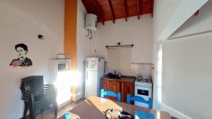 a small kitchen with a table and a refrigerator at Brisa de los Molles in Los Molles