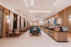 a restaurant with tables and chairs and a buffet at Basma Hotel Aswan in Aswan