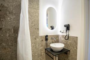 a bathroom with a sink and a mirror at Montelio Living in Ettlingen +77 photos