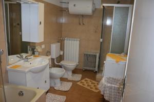 a bathroom with a toilet and a sink at Agriturismo Ghirlanda Norma Rita in Carrodano Inferiore +44 photos