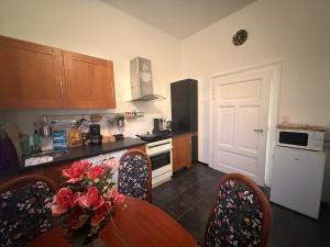 a kitchen with a table with roses on it at Ferienwohnung Margrit in Börßum +8 photos