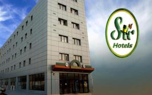 a hotel with a sign in front of a building at Hotel Sir Orhideea in Bucharest