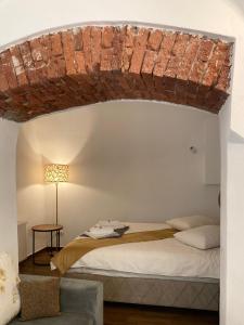 a bedroom with a bed with a brick ceiling at Old Town Sibiu Studio - Historical Center Residence in Sibiu