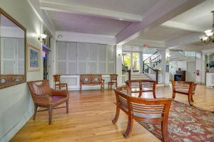 a living room with wooden chairs and a table at Kailua-Kona Studio - Walk to Hale Halawai Park! in Kailua-Kona