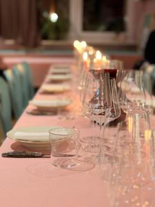 a long table with many wine glasses on it at Weinstockwerk Hotel St Peter in Nuremberg
