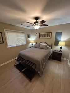 a bedroom with a bed and a ceiling fan at KSK Getaway in Nekoosa