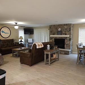 a living room with a couch and a fireplace at KSK Getaway in Nekoosa +18 photos