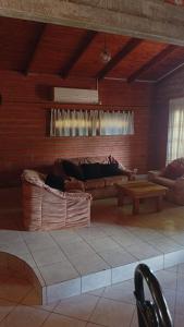 a living room with a couch and a table at Casa Paganelli Germano in Aristóbulo del Valle