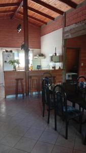 a room with a table and chairs and a kitchen at Casa Paganelli Germano in Aristóbulo del Valle
