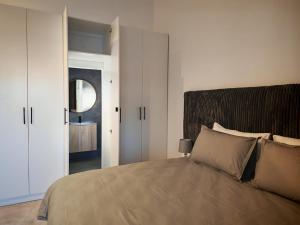 a bedroom with a large bed and a mirror at Kubata Diame B&B in Cape Town +20 photos