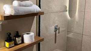a bathroom with a shower with a roll of toilet paper at Casa Celisa in Cali +72 photos