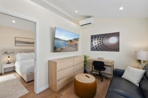 a bedroom with a bed and a couch and a desk at Luxury 1BR Suite Kitchen, Fireplace, Laundry, BBQ in Simi Valley