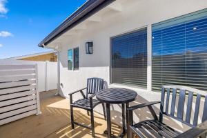 a patio with two chairs and a table and a stool at Luxury 1BR Suite Kitchen, Fireplace, Laundry, BBQ in Simi Valley