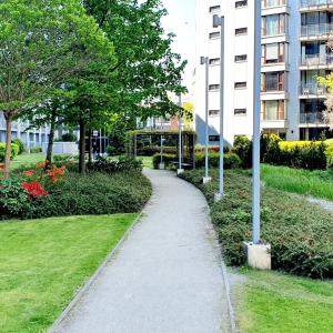 a path in a park next to a building at HomeComfort Atlantic Room in Warsaw