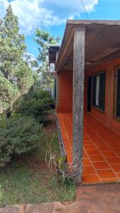 a house with an orange floor and a pillar at Casa Paganelli Germano in Aristóbulo del Valle