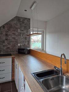 a kitchen with a sink and a counter top at Tündérkert Tündérfészek Vendégház in Sződliget