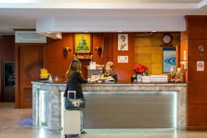 two women standing at a counter in a restaurant at THT by Thai Hotel Krabi in Krabi