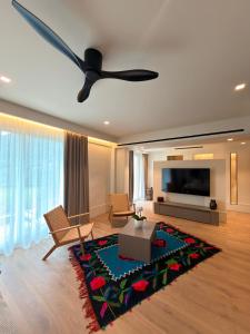 a living room with a couch and a ceiling fan at eleni's villa in Kandhíla