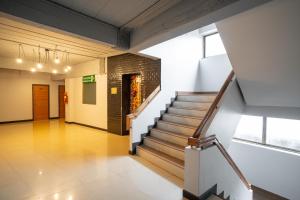 a hallway with a staircase in a building at THT by Thai Hotel Krabi in Krabi