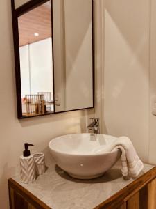 a bathroom with a white sink and a mirror at Casitas Amarillas in Uvita +38 photos