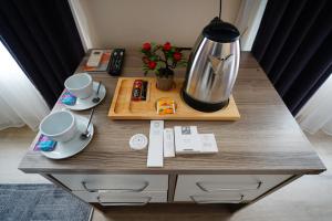 a table with a coffee pot and cups on it at The Apartment Galata in Istanbul