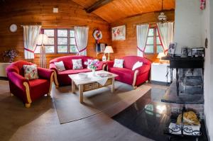 a living room with two red couches and a table at Bergblick Willingen in Neerdar