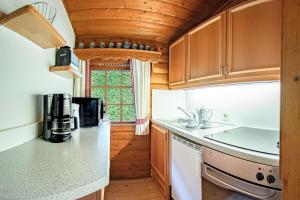 a kitchen with wooden cabinets and a counter top at Schwedenhaus Kaminzauber in Bömighausen