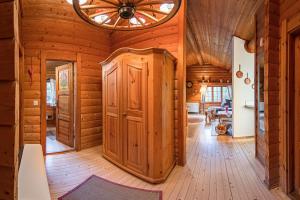 a log cabin hallway with a ceiling fan and wooden walls at Schwedenhaus Kaminzauber in Bömighausen +24 photos