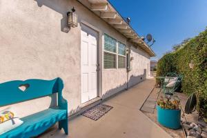 a blue bench sitting outside of a house at Cozy Villa with Spa, Fireplace, Kitchen, Yard, BBQ in Simi Valley